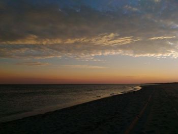 Scenic view of beach against sky during sunset