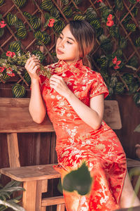 Full length of woman sitting outdoors