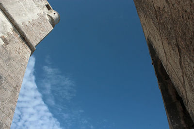 Low angle view of buildings against blue sky