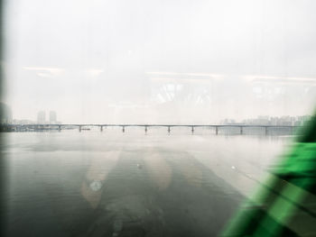 Reflection of buildings in water against sky