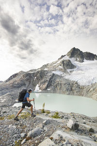 Backpacker hiking with view of lake and mountains