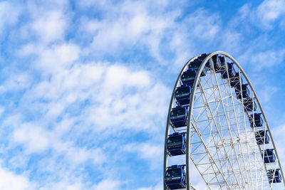 Low angle view of ferris wheel against sky