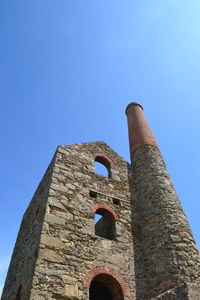 Low angle view of historic building against clear blue sky