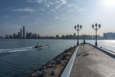 View of city by sea against sky