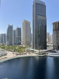 Modern buildings in city against clear sky