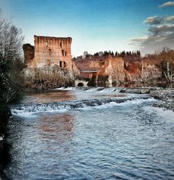 View of fort in river against sky