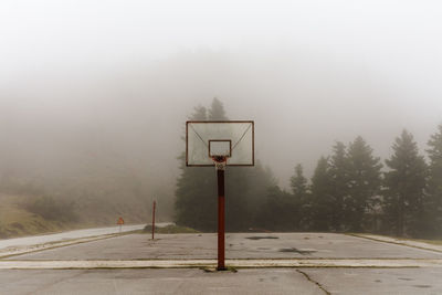 View of basketball hoop in foggy weather