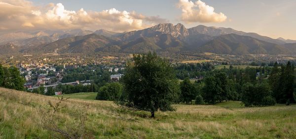 Scenic view of landscape and mountains against sky