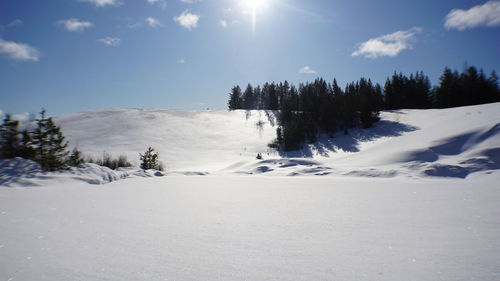 Scenic view of snow covered landscape against sky