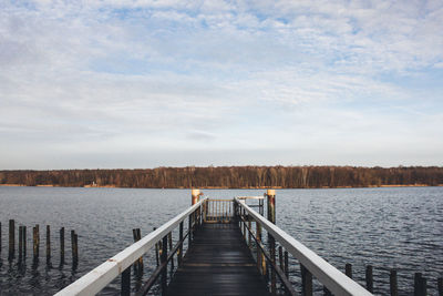 Pier over lake against sky