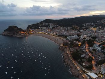 High angle view of sea and buildings against sky