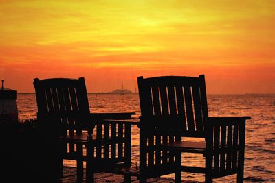 Pier on sea at sunset