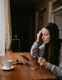 Young woman using mobile phone at home
