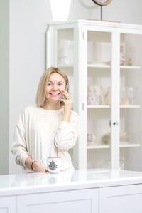 Portrait of young woman sitting at home