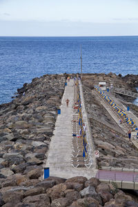 High angle view of rocks on beach against sky