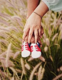 Midsection of woman hand on field