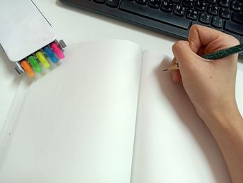 High angle view of person using laptop on table