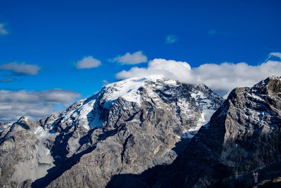 Scenic view of snowcapped mountains against blue sky