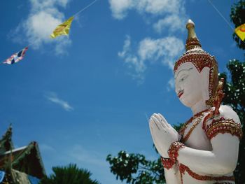 Low angle view of statue against blue sky