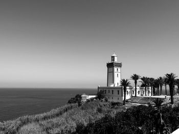 At the edge of the mediterranian sea - lighthouse by sea against clear sky