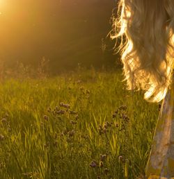 Woman with flowers on field