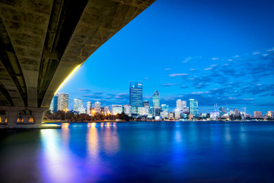 Illuminated city at waterfront
