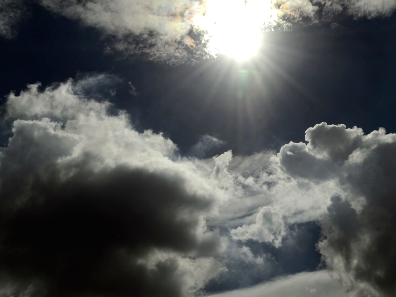 SUNLIGHT STREAMING THROUGH CLOUDS