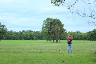 Full length of man standing on field against sky