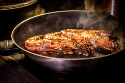 Grilled prawn in a frying pan on a dark background. seafood appetizer. preparation of  food.