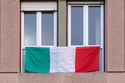 The italians locked up in the quarantined house display the rainbow flag on the windows