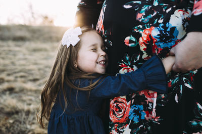 Loving daughter embracing mother at park