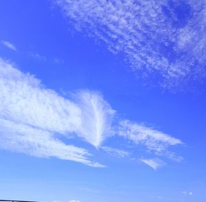 Low angle view of vapor trail in blue sky