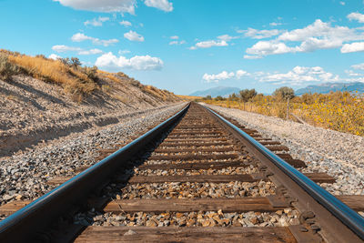 View of railroad tracks against sky in utah