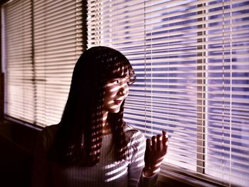 Portrait of woman looking away at home