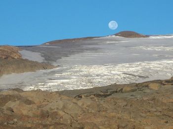 Scenic view of mountains against clear blue sky