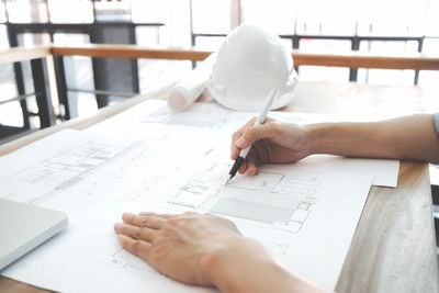 Cropped image of architect working at desk