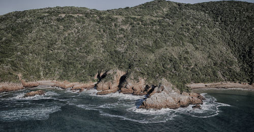 Scenic view of rocks on sea shore