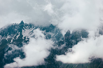 Scenic view of snow covered mountains against sky