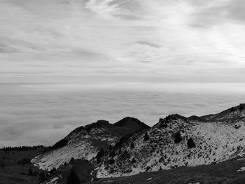 Scenic view of sea and mountains against sky