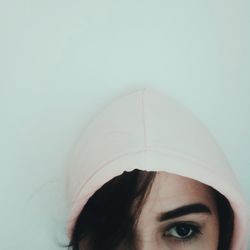 Close-up portrait of woman against white background