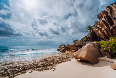 View of rocks on beach against sky