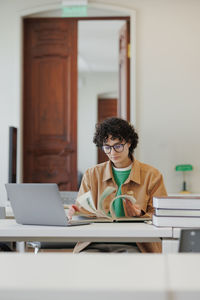 Young woman using laptop at office