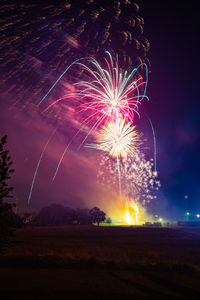 Low angle view of firework display at night