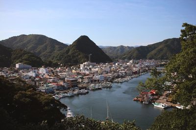 High angle view of town by mountains against clear sky