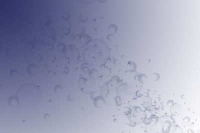 Abstract background of gradient light purple color with bubbles on the surface.