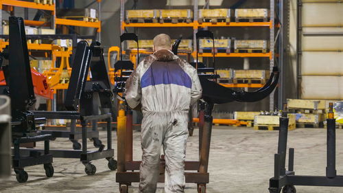 Rear view of man working at industry