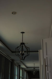 Low angle view of illuminated chandelier hanging in building