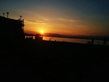 Scenic view of beach against sky during sunset