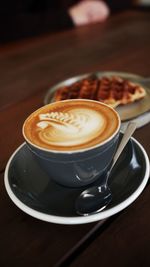 Close-up of cappuccino on table
