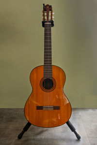 View of guitar on table against wall